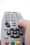A hand holding a remote